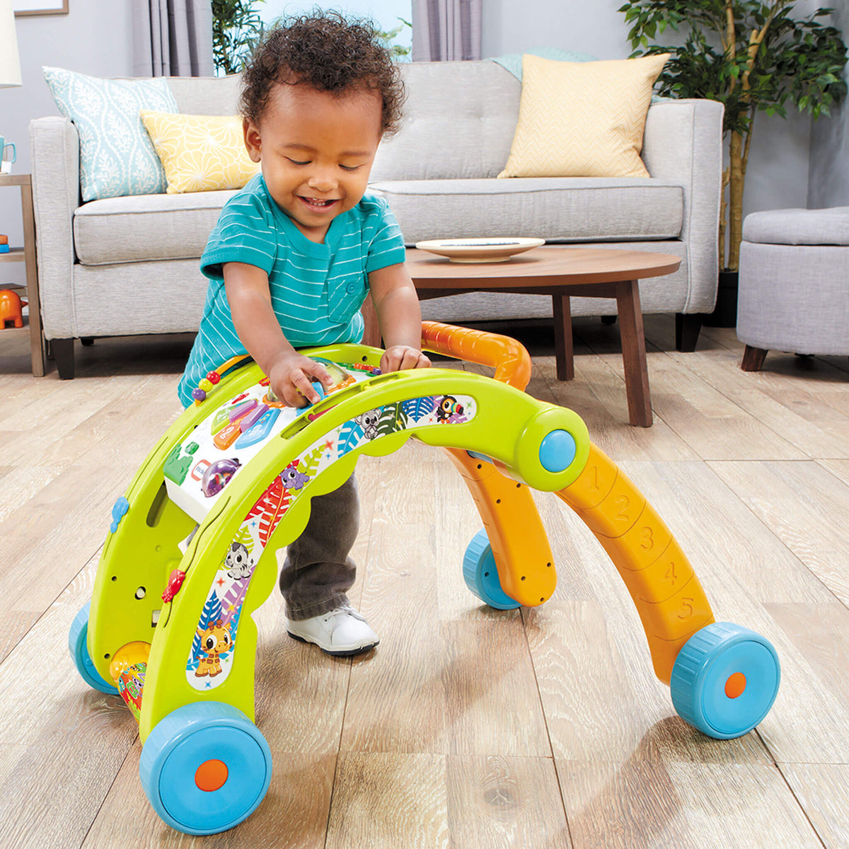 Child standing at walker playing
