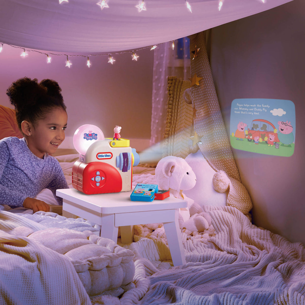 Child watching Peppa Pig on the wall in a cozy room with string lights.